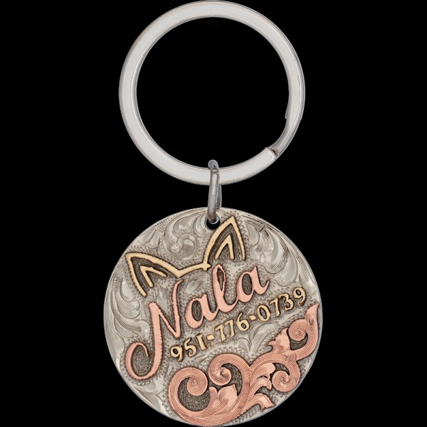 The Nala Custom Cat Tag! Crafted from durable German silver, this round tag features jeweler's bronze letters and adorable cat ears. Customize it now!
